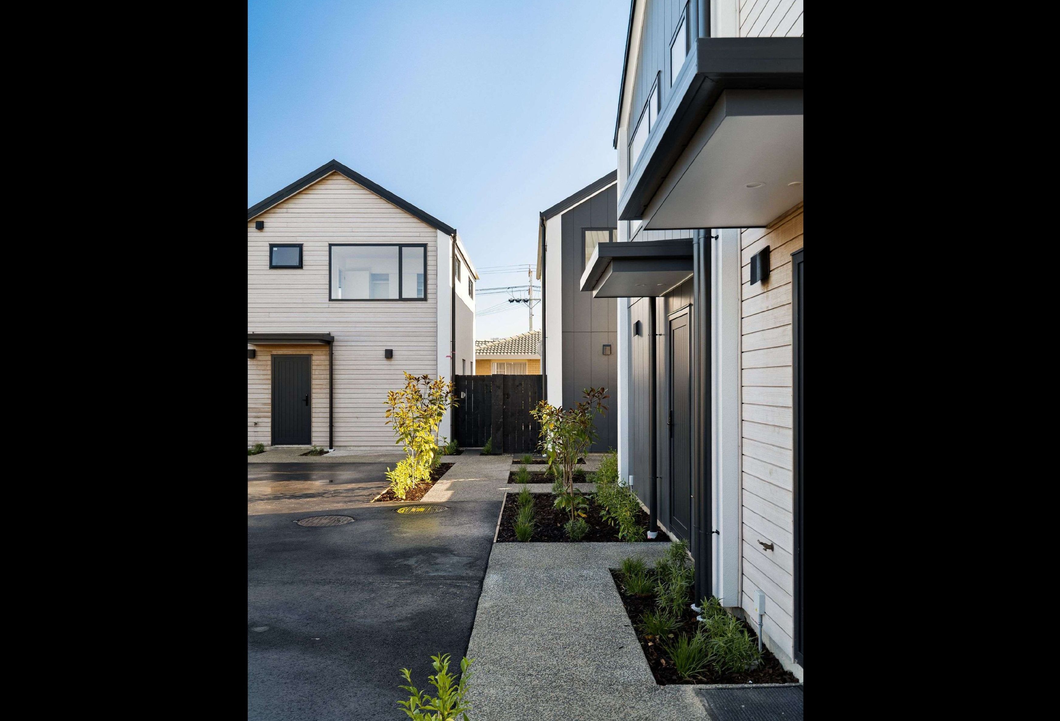 2-storey-townhouses-Stria-cladding-Abodo-weatherboard-Sto-render-exposed-concrete-path-planting-portrait